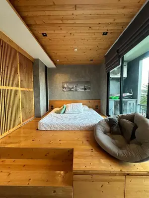a bedroom with a bed and a bean bag chair at ReLife The Windy NaiHarn (716) in Ban Saiyuan (1)