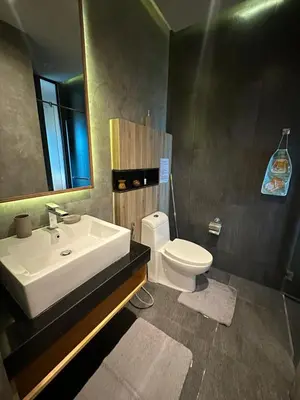 a bathroom with a sink and a toilet and a mirror at ReLife The Windy NaiHarn (716) in Ban Saiyuan (1)