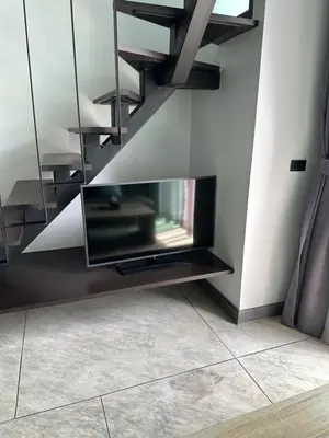 a living room with a tv and a fireplace at Utopia Naiharn Beach B16 in Rawai Beach