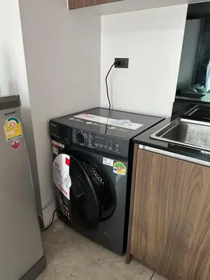 a black microwave oven in a kitchen next to a sink at Utopia Naiharn Beach B16 in Rawai Beach