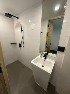 a white bathroom with a sink and a mirror at Utopia Naiharn Beach B17 in Rawai Beach