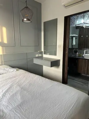 a bedroom with a white bed and a sink at Palmyrah Surin sea view in Surin Beach