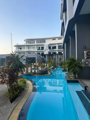 a swimming pool in front of a building at Duplex studio on Naiharn Beach B21 in Rawai Beach