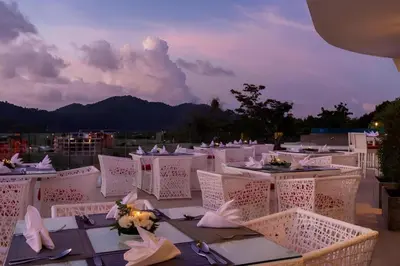 a table set up for a wedding with mountains in the background at Duplex studio on Naiharn Beach B21 in Rawai Beach