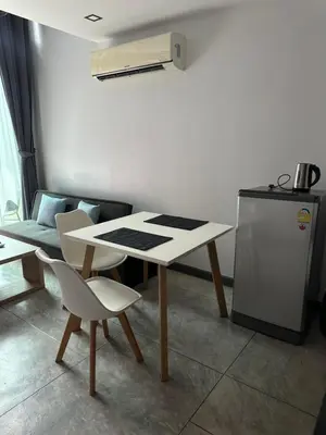 a room with a table and chairs and a refrigerator at Duplex studio on Naiharn Beach B21 in Rawai Beach