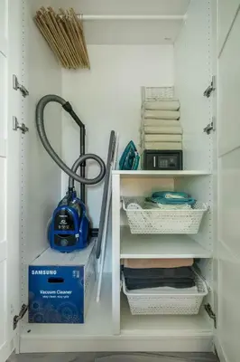 a room with a shelf with a vacuum and a box at Studio Apartment by the Sea E413 in Phuket Town