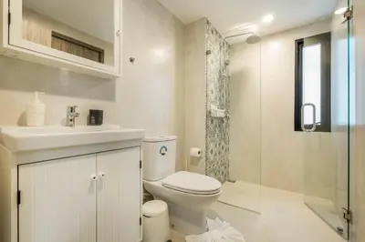 a bathroom with a toilet and a sink and a shower at Studio Apartment by the Sea E413 in Phuket Town