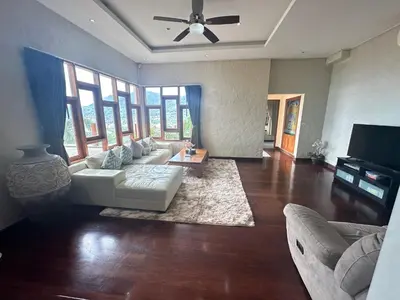 a living room with a couch and a table at Villa Moon Talay View in Patong Beach