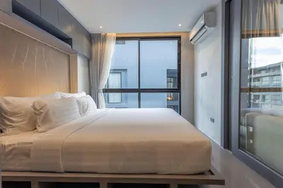 a bedroom with a large bed with a large window at C141 Fully Loaded Best Facilities Nicest Apartment in Kamala Beach