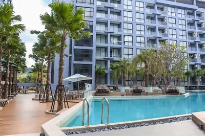 a hotel with a swimming pool and a large building at C141 Fully Loaded Best Facilities Nicest Apartment in Kamala Beach