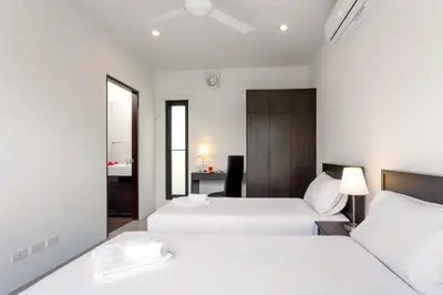 a bedroom with two beds and a desk in it at Tropical 3BR Pool Villa Nga Chang NC10, Gated Residence, 10 min Drive to Nai Harn Beach in Rawai Beach
