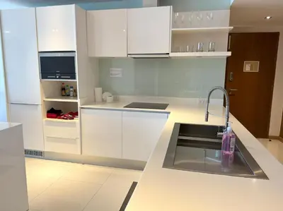a kitchen with white cabinets and a sink at Sea view apartment at Privilege by Lofty in Patong Beach