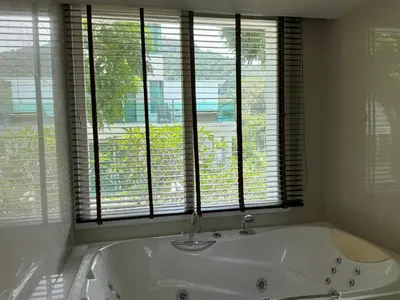 a white bath tub in a bathroom with windows at Sea view apartment at Privilege by Lofty in Patong Beach