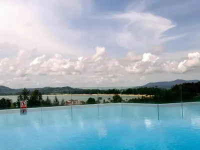 a large swimming pool with a view of the water at Sea view apartment at Aristo2 by Lofty in Surin Beach