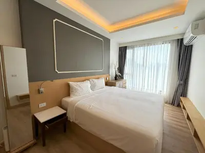 a bedroom with a large white bed with a large window at Sea view apartment at Aristo2 by Lofty in Surin Beach