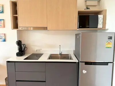 a kitchen with a sink and a refrigerator at Sea view apartment at Aristo2 by Lofty in Surin Beach