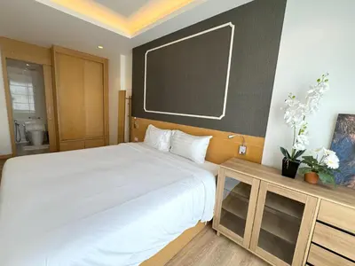 a bedroom with a large bed and a chalkboard on the wall at Sea view apartment at Aristo2 by Lofty in Surin Beach