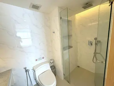 a bathroom with a toilet and a glass shower at Sea view apartment at Aristo2 by Lofty in Surin Beach