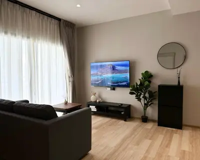 a living room with a couch and a flat screen tv at The Title Halo 1 Apartment 10 min to Nai Yang Beach in Nai Yang Beach
