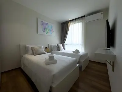 a hotel room with two beds and a window at The Title Halo 1 Apartment 10 min to Nai Yang Beach in Nai Yang Beach