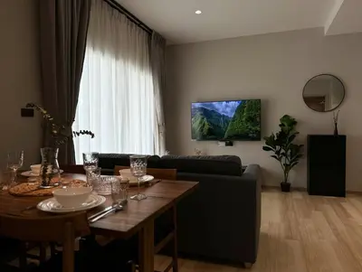 a living room with a table and a couch at The Title Halo 1 Apartment 10 min to Nai Yang Beach in Nai Yang Beach