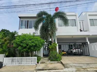 a white house with a palm tree in front of it at Andaman homestay villa at rawai in Ban Saiyuan (1)