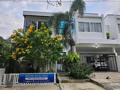 a house with a sign in front of it at Andaman homestay villa at rawai in Ban Saiyuan (1)