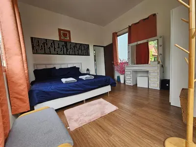 a bedroom with a blue bed and a desk at Andaman homestay villa at rawai in Ban Saiyuan (1)