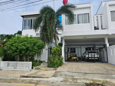 a white house with a palm tree in front of it at Andaman homestay villa at rawai in Ban Saiyuan (1)