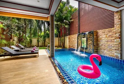 a swimming pool with a pink swan in a house at Private Villas Bangtao in Bang Tao Beach