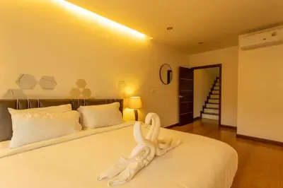 a bedroom with a bed with a towel animal on it at 12 minutes Patong Security Gym Sauna AP12 #V28 in Kamala Beach