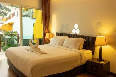 a bedroom with a bed with two swans on it at 12 minutes Patong Security Gym Sauna AP12 #V28 in Kamala Beach