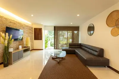 a living room with a leather couch and a glass table at 12 minutes Patong Security Gym Sauna AP12 #V28 in Kamala Beach