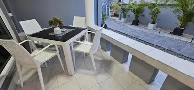 a table and chairs on the balcony of a house at Prestige Pool Villa by Karon Homes in Karon Beach