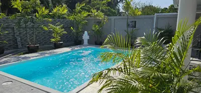 a swimming pool in a yard with plants at Prestige Pool Villa by Karon Homes in Karon Beach