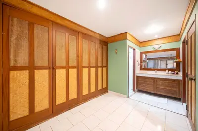 a bathroom with wooden sliding doors and a sink at Unique Style 3BR Apartment BGV 216 in Gated Residence, Kata in Kata Beach