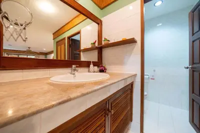 a bathroom with a sink and a mirror at Unique Style 3BR Apartment BGV 216 in Gated Residence, Kata in Kata Beach