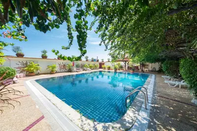 a swimming pool in a yard with trees at Unique Style 3BR Apartment BGV 216 in Gated Residence, Kata in Kata Beach