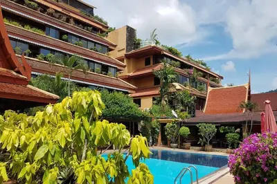 a hotel with a swimming pool in front of a building at Unique Style 3BR Apartment BGV 216 in Gated Residence, Kata in Kata Beach