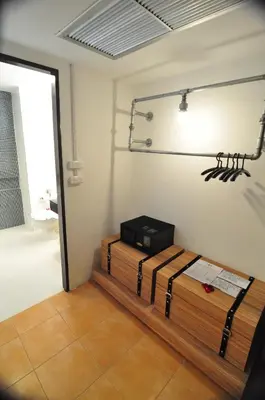 a room with a room with a table and a light at Forty Winks Phuket Hotel in Patong Beach