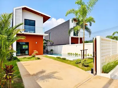 a house with an orange and white facade at Krabi Private Pool Villa 1 by Belcarrra Spaces in Ban Khlong Haeng