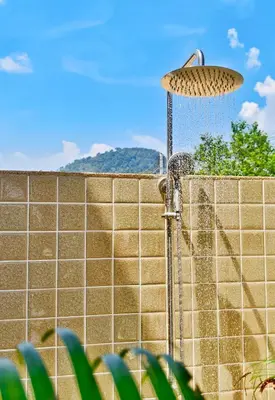 a shower in front of a brick wall at Krabi Private Pool Villa 1 by Belcarrra Spaces in Ban Khlong Haeng