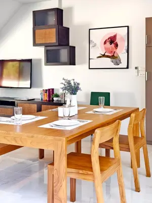 a dining room with a wooden table and chairs at Krabi Private Pool Villa 1 by Belcarrra Spaces in Ban Khlong Haeng