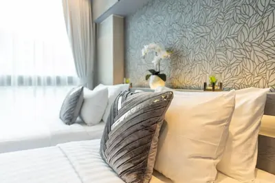 a hotel room with a couch and pillows at Nicest Condo in City gate Kamala 6km Patong #c118 in Kamala Beach