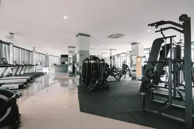 a gym with treadmills and machines in a room at Nicest Condo in City gate Kamala 6km Patong #c118 in Kamala Beach