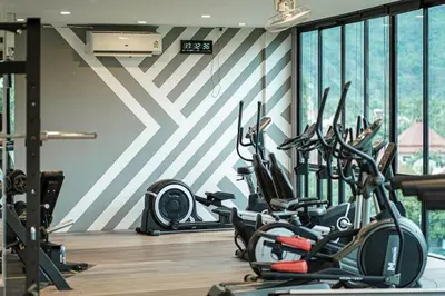 a gym with several exercise bikes in a room at Nicest Condo in City gate Kamala 6km Patong #c118 in Kamala Beach