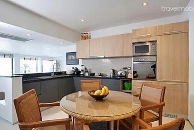a kitchen with a table with a bowl of fruit on it at Atika Villas in Patong Beach