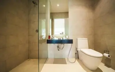 a bathroom with a toilet and a sink at Atika Villas in Patong Beach