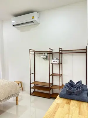 a living room with a heater on the wall at JK Studio, Koh Yao Noi in Ko Yao Noi