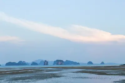 a view of the beach with rocks in the water at JK Studio, Koh Yao Noi in Ko Yao Noi